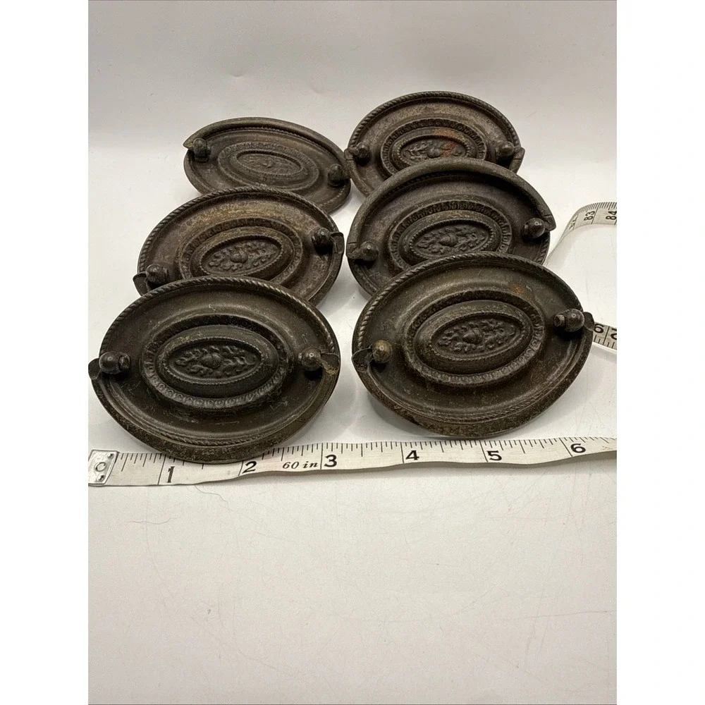 Antique Hepplewhite-style drawer pulls embossed oval backplate